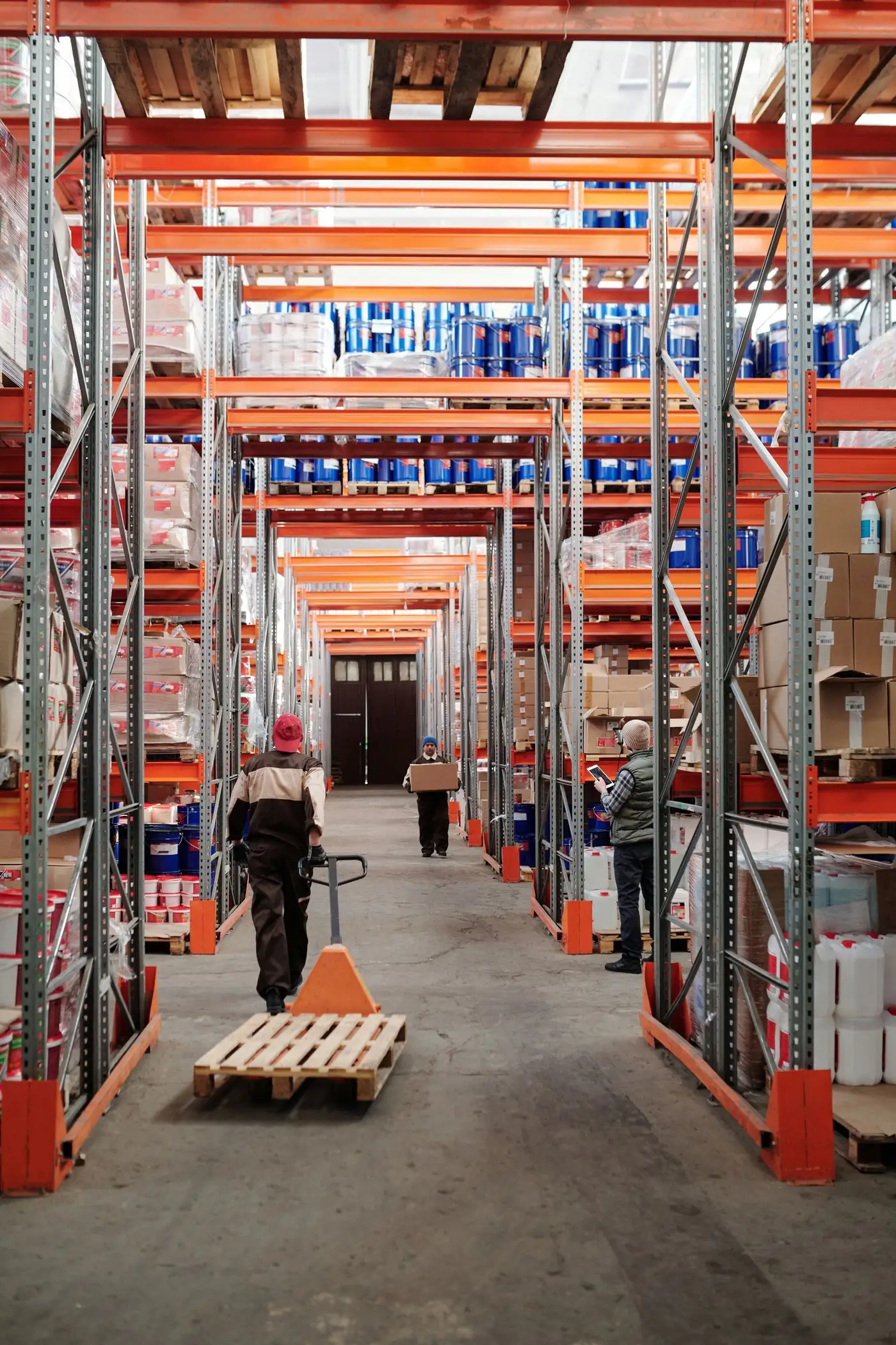 Long warehouse aisle between rows of stocked shelving