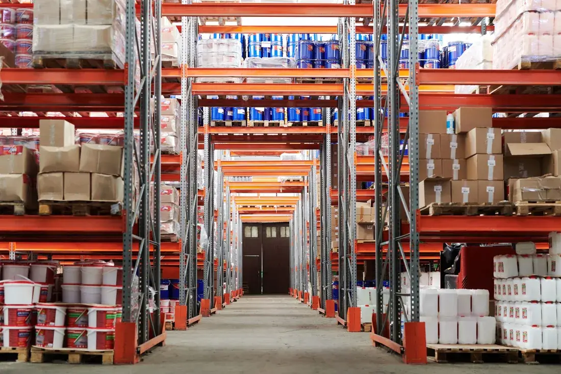 Warehouse aisle with tall orange pallet racking