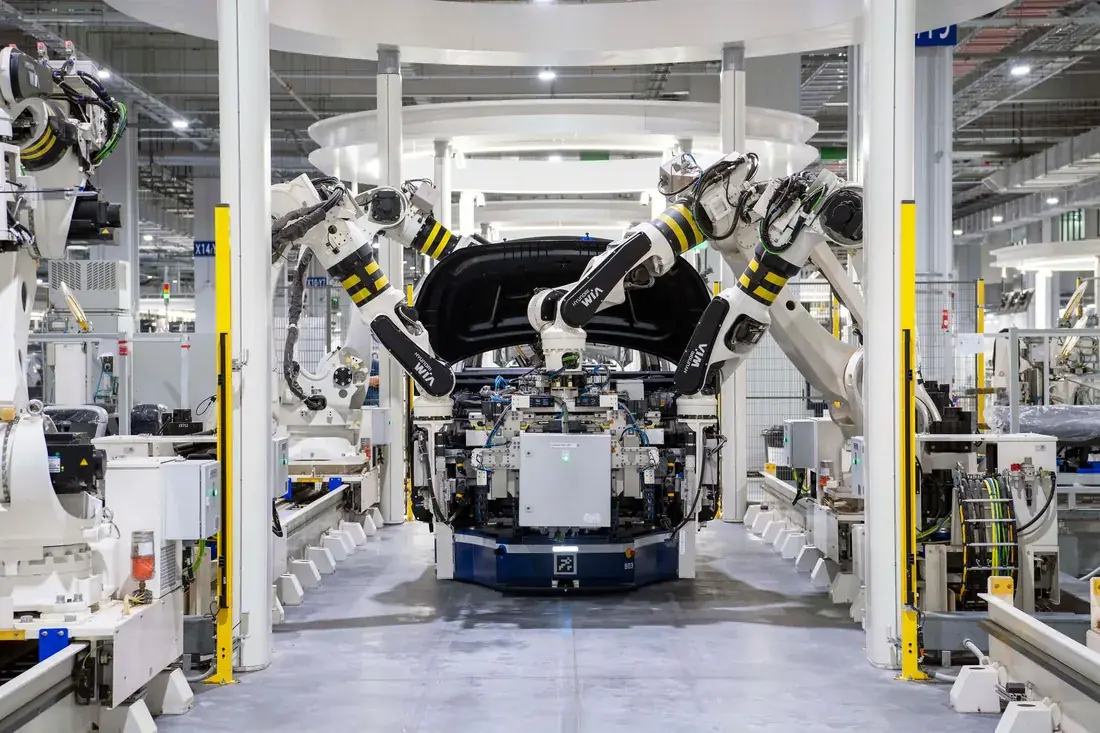 Car body on an automated assembly line with robotic arms